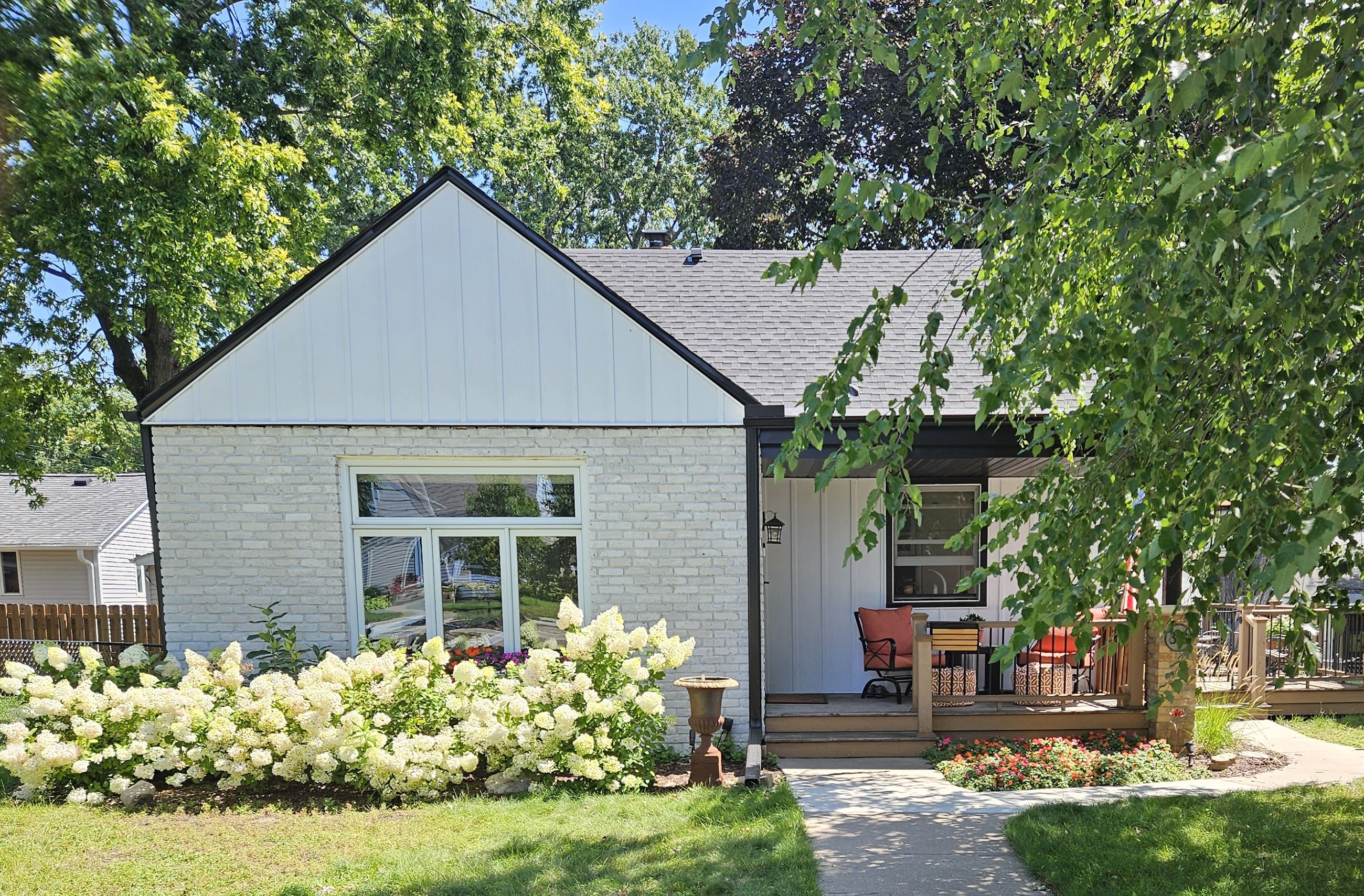 313 7th Avenue N before renovation, brick is painted and white and landscaping is nice