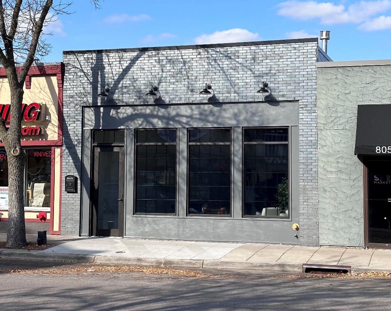 809 Mainstreet before renovation. Windows are boarded up and dark and dreary